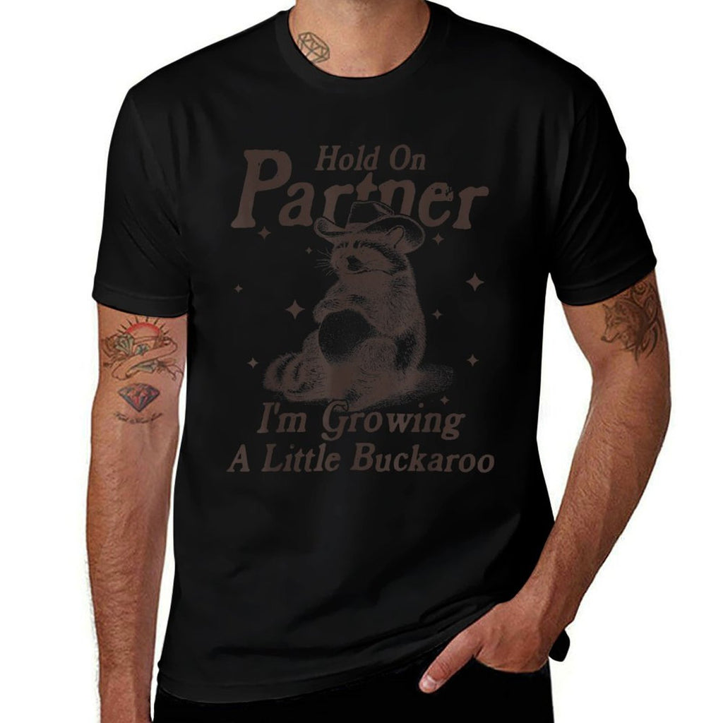 Hold On Partner Im Growing A Little Buckaroo Funny Raccoon  Affordable Price T-Shirt