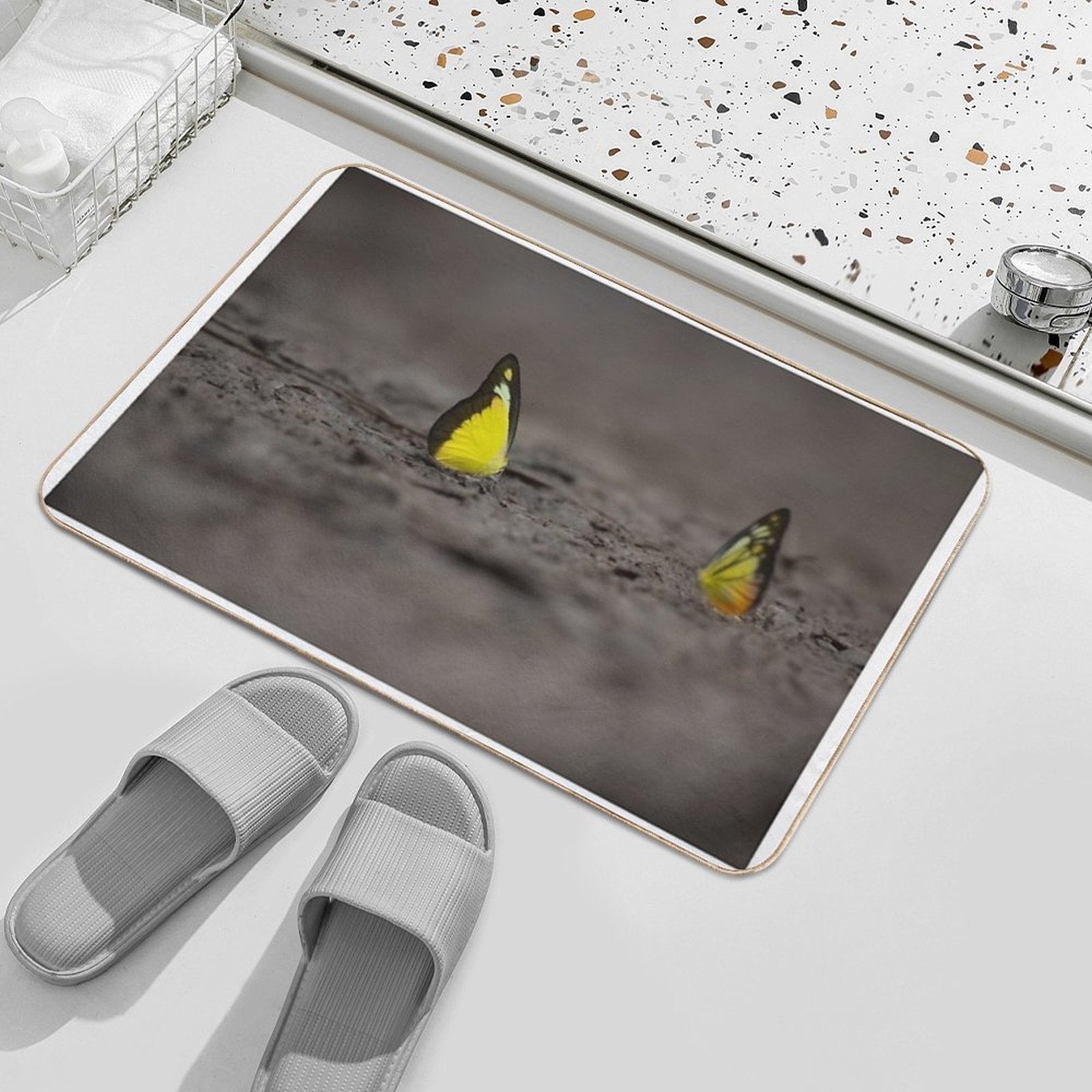 This Image Captures A Brightly Colored Butterfly Settled on Rugged Terrain, Offering A Striking Contrast Between Fragility And R  Versatile Bath Mat